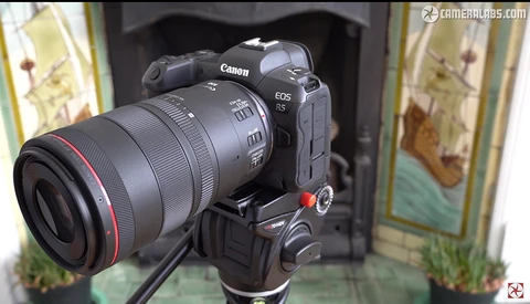 Canon EOS R5 mirrorless camera with telephoto lens mounted on tripod head.