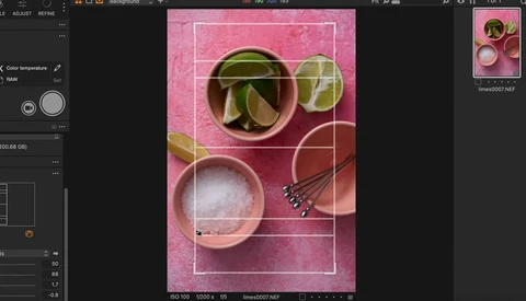 Screenshot of photo editing software displaying a styled flat lay with cocktail ingredients on a pink background.