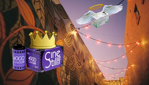 Neon sign for CineStills film stock mounted on brick building at dusk with string lights and winged delivery box illustration.