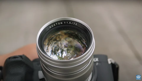 Horton 1:1.5776 telephoto lens mounted on camera body, showing spherical aberration and lens distortion in reflection.