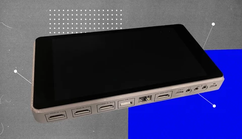 Illustration of a tablet device with multiple USB ports along its edge against a split gray and blue background.