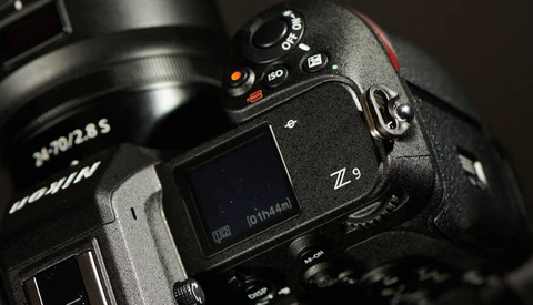 Nikon Z9 mirrorless camera with attached telephoto lens on dark surface.