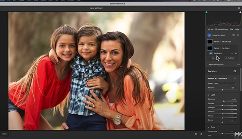 Three women and a young child posing together outdoors with warm, natural backlighting.