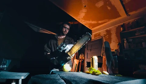 Photographer working inside a van at night, illuminated by warm artificial light while holding a camera.