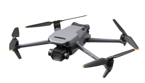 Gray and black quadcopter drone with folded arms shown against a white background.