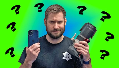 Man holding smartphone and camera lens against colorful gradient background with question marks.