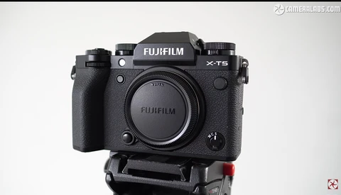 Fujifilm X-T5 mirrorless camera body mounted on a tripod plate, front view.