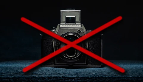 Vintage medium format camera with a large red X overlaid across it.