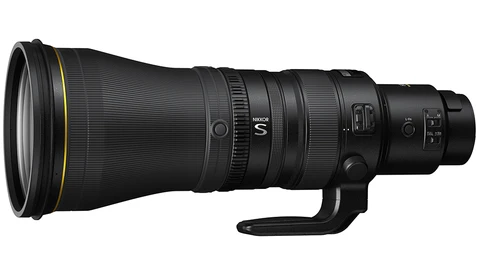 Black telephoto lens with gold accents and control rings mounted on white background.