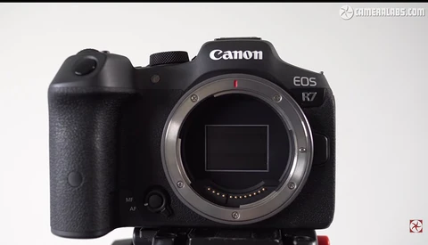 Canon EOS R7 mirrorless camera body shown from front with lens mount exposed.