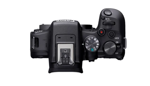 Top-down view of a black mirrorless camera body with dual control wheels and accessory shoe.