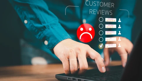 Person using laptop with digital customer review interface overlay showing ratings and feedback options.