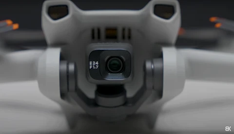 Close-up of a drone's camera gimbal showing f2.8 and f1.7 aperture settings on the lens.
