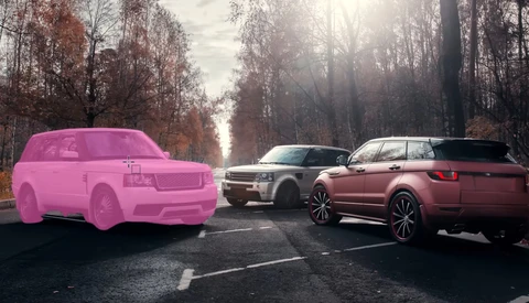 Three SUVs parked on a tree-lined road; the leftmost vehicle is rendered in bright pink while the other two are photorealistic.