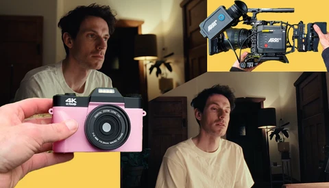 Hand holding a pink 4K instant camera against a yellow background.