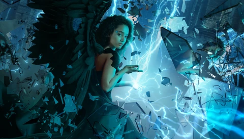 Woman surrounded by glowing blue energy and shattering glass fragments in a digital composite.