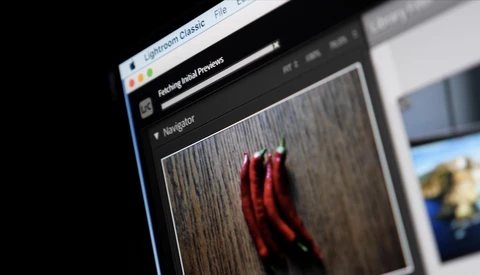 Screenshot of photo editing software showing red chili peppers on a wooden surface in the preview panel.