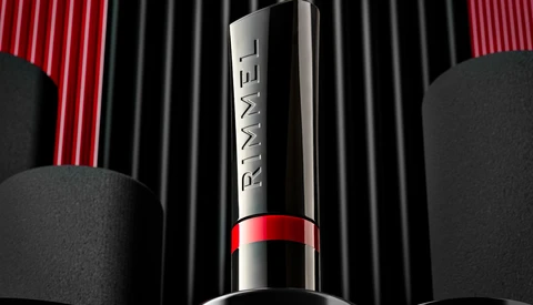 Luxury cosmetic product shot featuring a silver and red lipstick against striped backdrop with spherical elements.
