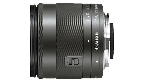 Canon EF-M 18-55mm f/3.5-5.6 IS STM lens with textured barrel and control buttons visible.
