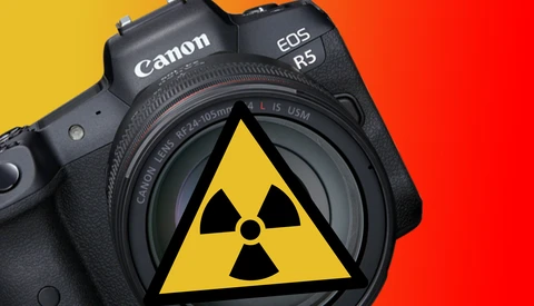 Canon EOS R5 mirrorless camera with a radiation hazard symbol displayed on its sensor against a yellow and red gradient background.