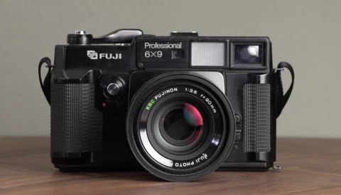 Fuji Professional 6×9 rangefinder camera with a black body and textured grip panels, featuring a Fujinon lens.