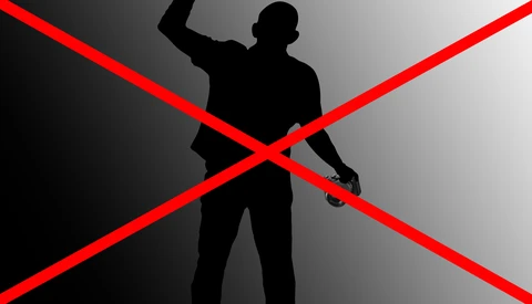 Silhouette of a man with a rifle crossed out by red X marks on a gradient background.