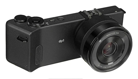 The Sigma dp1 Merrill compact camera with fixed prime lens, shown at a three-quarter angle against a white background.
