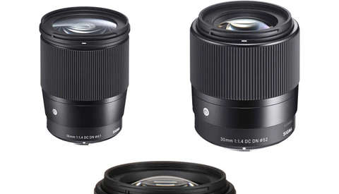 Three black camera lenses with ribbed focus rings displayed against a white background.