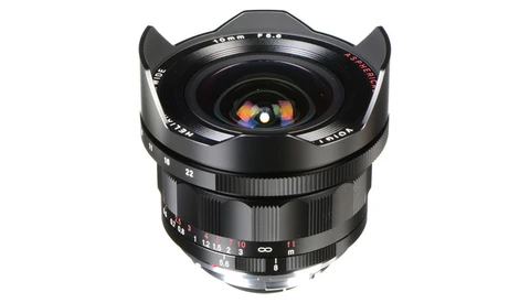 Wide-angle manual focus lens with prominent front optics and metal hood against white background.