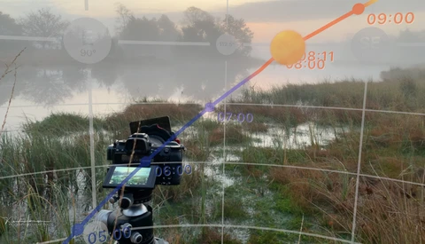 Camera mounted on a tripod overlooking a misty wetland with time-lapse visualization overlay.