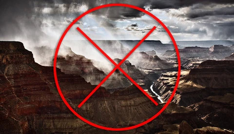 Grand Canyon landscape with red prohibition symbol overlaid.