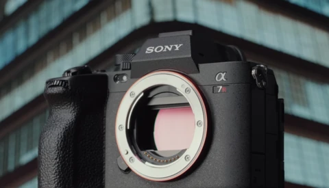Sony Alpha mirrorless camera body with lens mount exposed against architectural background.