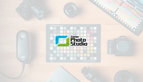 Logo for Zoner Photo Studio displayed on a tablet surrounded by photography equipment.