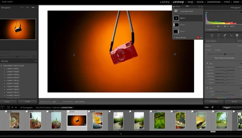 Red vintage camera suspended by a black strap against a warm orange gradient background.