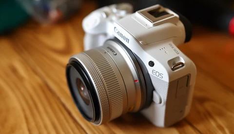 Canon EOS M50 Mark II mirrorless camera with Canon EF-M 15-45mm lens on wooden surface.