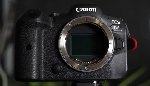 Canon EOS R6 mirrorless camera body with lens mount open, showing the sensor and mirror mechanism from the front.