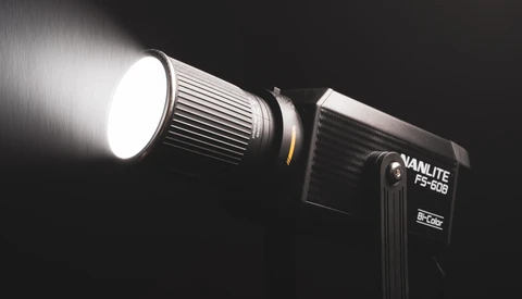 Vanlite FS-60B LED light fixture mounted on stand with bright white spotlight beam against dark background.