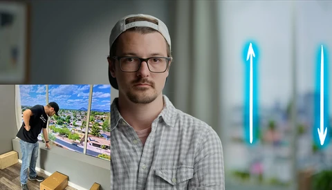 Photographer holding a landscape photograph while standing in front of a blurred cityscape window, with blue neon arrows pointing upward on either side.