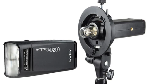 Godox Witstro AD200 compact flash unit and mounting bracket with reflector displayed side by side.