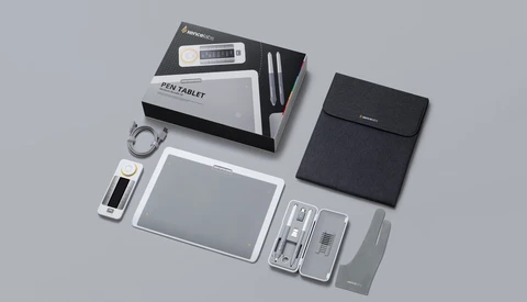 Flat lay of a pen tablet and accessories arranged on a neutral gray surface.