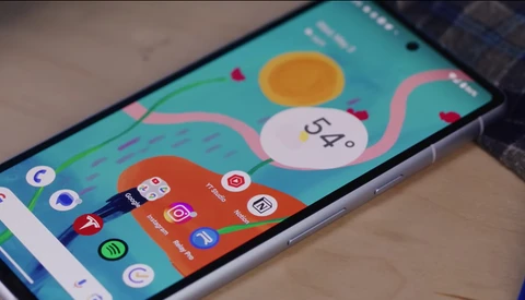 Smartphone displaying a colorful homescreen with weather widget showing 54 degrees and various app icons on a turquoise background.