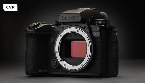 Panasonic Lumix full-frame mirrorless camera body with open sensor housing against dark background.