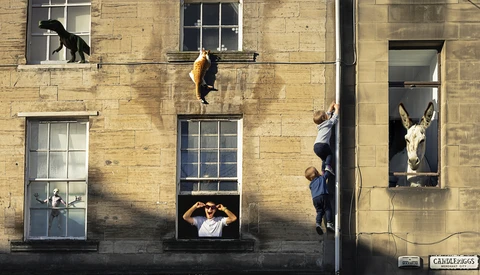 Composite street art featuring taxidermied animals arranged on a building facade with windows and figures interacting with them.