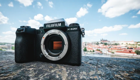 Fujifilm X-S20 camera body displayed on a stone surface with a cityscape in the background.