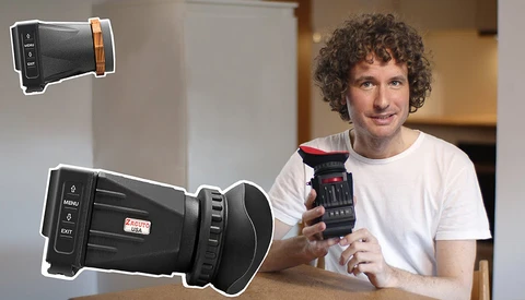 Man holding a thermal imaging camera while demonstrating handheld thermal devices.
