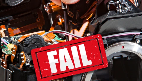 Red FAIL stamp overlaid on internal circuitry and mechanical components of an electronic device.