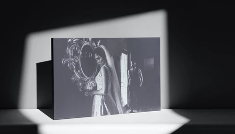 Black and white photograph displayed as a 3D printed or sculptural object with dramatic directional lighting casting shadows.