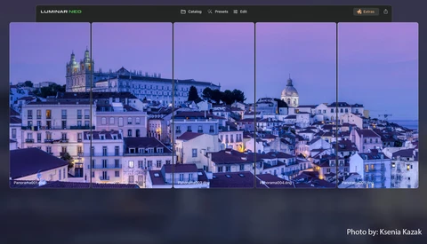 Hillside European cityscape at dusk with illuminated buildings and churches ascending a slope.