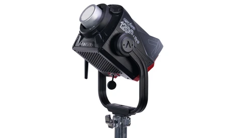 Black professional LED spotlight with adjustable head mounted on a stand against white background.