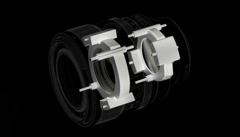 Cutaway illustration of a camera lens showing internal optical elements and mechanical components.